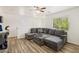 Bright living room featuring a large sectional sofa, wood-style flooring, and natural light at 6313 Pangea Ave, Las Vegas, NV 89139