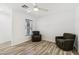 Bright living room with wood-look floors, ceiling fan, and comfortable seating at 6313 Pangea Ave, Las Vegas, NV 89139