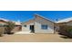 A spacious backyard featuring a concrete patio, desert landscaping, and a rear house elevation at 6615 Elk Creek Ln, Las Vegas, NV 89156