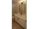 Bathroom featuring a white vanity with marble countertop, black fixtures, and modern lighting at 6615 Elk Creek Ln, Las Vegas, NV 89156
