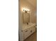 Bathroom features white cabinets, quartz countertops, stainless steel hardware, and modern lighting at 6615 Elk Creek Ln, Las Vegas, NV 89156
