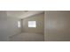 A spacious bedroom with neutral walls, carpeted floor, and a high ceiling with natural light coming through the window at 6615 Elk Creek Ln, Las Vegas, NV 89156
