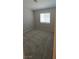 A clean, carpeted bedroom with neutral walls and natural light, creating a bright and inviting atmosphere at 6615 Elk Creek Ln, Las Vegas, NV 89156