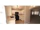 Bright kitchen featuring white cabinets, stainless steel appliances, quartz countertops, and a view into an adjacent room at 6615 Elk Creek Ln, Las Vegas, NV 89156