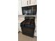 Stainless steel oven and microwave with white cabinets and quartz countertops at 6615 Elk Creek Ln, Las Vegas, NV 89156