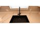 Modern black sink with quartz countertops and stainless steel hardware at 6615 Elk Creek Ln, Las Vegas, NV 89156