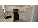 Kitchen features white cabinets, quartz countertops, stainless steel appliances, and laminate flooring at 6615 Elk Creek Ln, Las Vegas, NV 89156