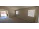 Spacious living room with neutral color palette, ample natural light, and an arched doorway at 6615 Elk Creek Ln, Las Vegas, NV 89156