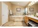 Light and airy bathroom boasts a separate soaking tub and dual vanity at 6617 Golden Bit Ave, Las Vegas, NV 89131