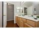 Bathroom vanity featuring double sinks, wood cabinets, and a large mirror at 6617 Golden Bit Ave, Las Vegas, NV 89131