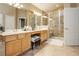 Dual sink bathroom with tile floors, glass shower, and separate vanity at 6617 Golden Bit Ave, Las Vegas, NV 89131