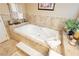 Spacious bathroom includes a soaking tub, towel, and tile surround at 6617 Golden Bit Ave, Las Vegas, NV 89131