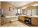 Well-lit bathroom with a separate soaking tub and dual vanity at 6617 Golden Bit Ave, Las Vegas, NV 89131