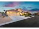 Suburban home with well-kept landscaping, desert accents and a long driveway at 6617 Golden Bit Ave, Las Vegas, NV 89131