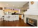 Bright kitchen featuring an island with seating, a fireplace, and ample countertop space at 6617 Golden Bit Ave, Las Vegas, NV 89131