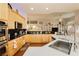 Modern kitchen with black countertops, light wood cabinetry, and stainless steel appliances at 6617 Golden Bit Ave, Las Vegas, NV 89131