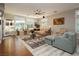 Sun-filled living room with large windows, a cozy sectional sofa, and stylish decor at 6617 Golden Bit Ave, Las Vegas, NV 89131