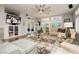 Bright living room with large windows, comfortable seating, and a modern ceiling fan for relaxed living at 6617 Golden Bit Ave, Las Vegas, NV 89131