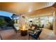 Covered patio with a fire pit, comfortable seating, and an outdoor dining area at 6617 Golden Bit Ave, Las Vegas, NV 89131