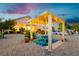 Charming pergola with string lights, creating a cozy outdoor dining area by the pool at 6617 Golden Bit Ave, Las Vegas, NV 89131