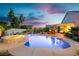 Beautiful backyard pool and hot tub featuring lush landscaping and ambient lighting at 6617 Golden Bit Ave, Las Vegas, NV 89131