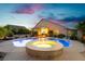 Inviting backyard pool and spa featuring lush landscaping, an outdoor seating area, and a beautiful sunset sky at 6617 Golden Bit Ave, Las Vegas, NV 89131