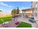 Backyard featuring a patio, artificial grass, and outdoor seating, providing a relaxing outdoor oasis at 7032 Wonderberry St, Las Vegas, NV 89131