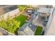 Aerial view of backyard featuring a patio area, artificial grass, seating, and a storage shed at 7032 Wonderberry St, Las Vegas, NV 89131
