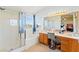 Bright bathroom with a glass-enclosed shower, soaking tub, and dual vanity at 7032 Wonderberry St, Las Vegas, NV 89131