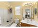 Bathroom with tub/shower combination, decorative mirror and vanity with cabinet storage at 7032 Wonderberry St, Las Vegas, NV 89131