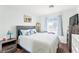 Comfortable bedroom with a queen bed, soft colors and natural light from a bright window at 7032 Wonderberry St, Las Vegas, NV 89131