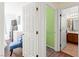 Bright bedroom featuring a cozy blue chair and ensuite bathroom for added convenience at 7032 Wonderberry St, Las Vegas, NV 89131