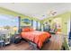 Bedroom with natural light, a ceiling fan, hardwood flooring, and a view of the backyard at 7032 Wonderberry St, Las Vegas, NV 89131