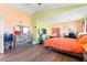 A bedroom featuring a pallet bed frame, dresser, and tv stand, with hardwood floors at 7032 Wonderberry St, Las Vegas, NV 89131