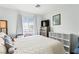Serene bedroom with a queen bed, dresser, and bright window providing plenty of natural light at 7032 Wonderberry St, Las Vegas, NV 89131
