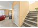 Entryway with staircase leading upstairs and views of the living room with tile flooring at 7032 Wonderberry St, Las Vegas, NV 89131