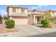 Charming two-story home with a well-manicured lawn, desert landscaping, and an attached two-car garage at 7032 Wonderberry St, Las Vegas, NV 89131
