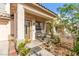 Charming front porch with desert landscaping, a bench and providing a warm entry to the home at 7032 Wonderberry St, Las Vegas, NV 89131