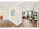 Hallway showcasing hardwood floors leading to a bedroom with natural light and a ceiling fan at 7032 Wonderberry St, Las Vegas, NV 89131