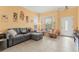 Inviting living room featuring a comfortable grey sofa, colorful décor, and tile flooring at 7032 Wonderberry St, Las Vegas, NV 89131