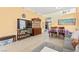 Open-concept living and dining area with tile flooring, neutral tones and modern furnishings at 7032 Wonderberry St, Las Vegas, NV 89131