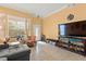Stylish living room with a large TV, comfortable sofa, ample seating, and bright natural light at 7032 Wonderberry St, Las Vegas, NV 89131