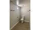 Bathroom featuring a toilet, light fixture, and black hardware at 8101 W Flamingo Rd # 1102, Las Vegas, NV 89147