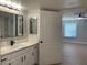 Bathroom featuring a white vanity with quartz countertop, black hardware, and a rectangular framed mirror at 8101 W Flamingo Rd # 1102, Las Vegas, NV 89147