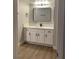 Bathroom featuring a white vanity with quartz countertop, black hardware, and a rectangular framed mirror at 8101 W Flamingo Rd # 1102, Las Vegas, NV 89147