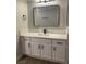 Bathroom featuring a white vanity with quartz countertop, black hardware, and a rectangular framed mirror at 8101 W Flamingo Rd # 1102, Las Vegas, NV 89147