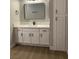 Bathroom featuring a white vanity with quartz countertop, black hardware, and a rectangular framed mirror at 8101 W Flamingo Rd # 1102, Las Vegas, NV 89147