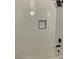 Bathtub with white subway tile surround, black hardware, and shower niche at 8101 W Flamingo Rd # 1102, Las Vegas, NV 89147