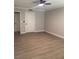 A light-filled bedroom with neutral walls and plank flooring has 2 white doors at 8101 W Flamingo Rd # 1102, Las Vegas, NV 89147
