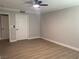 A light-filled bedroom with neutral walls and plank flooring has 2 white doors at 8101 W Flamingo Rd # 1102, Las Vegas, NV 89147